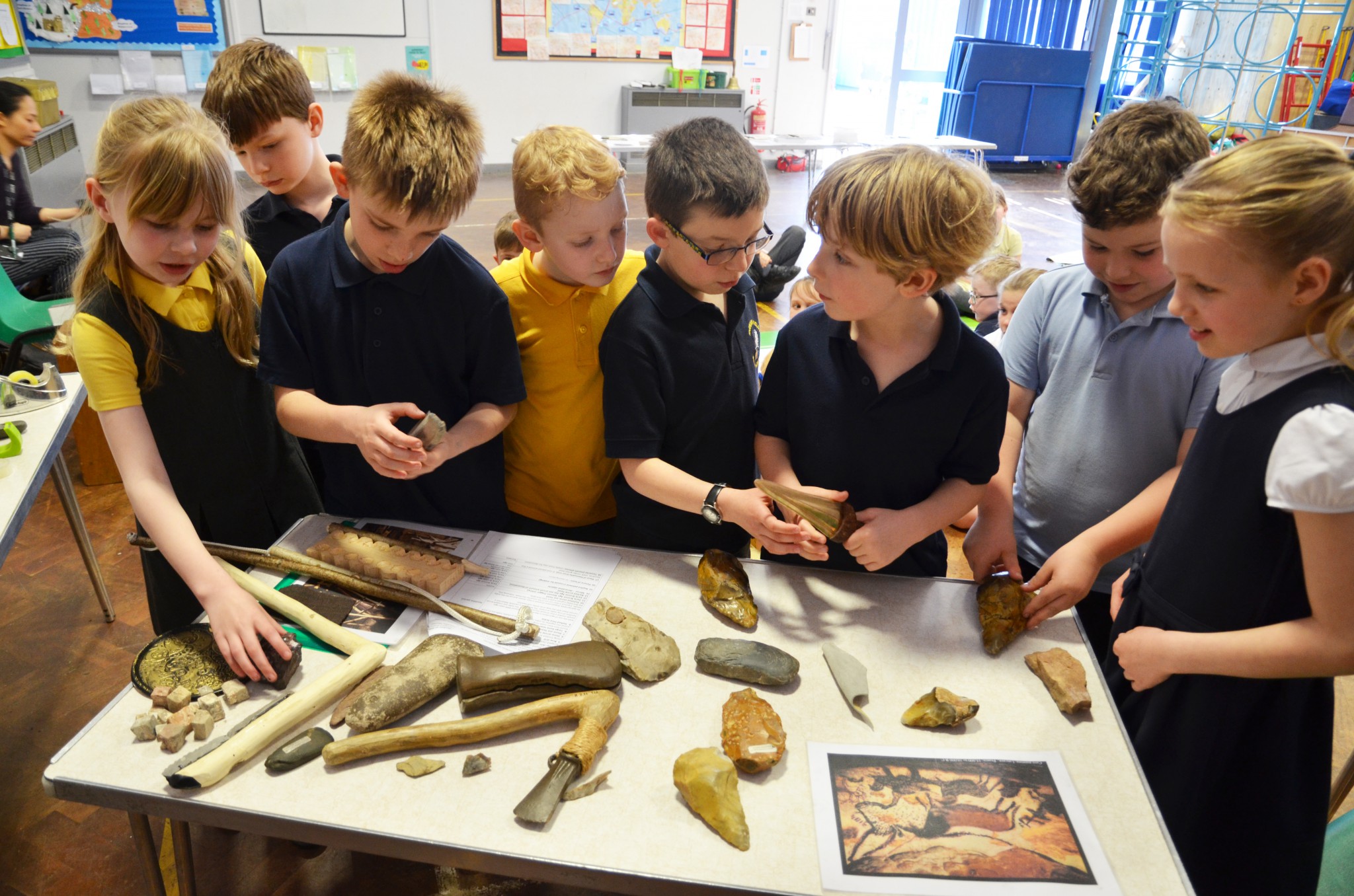 Photo of children looking at Stone Age tools