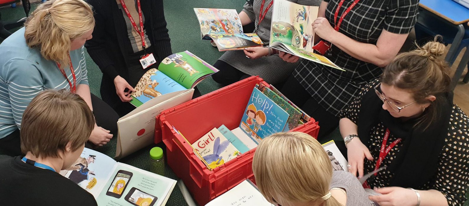 Photo of teachers reading books