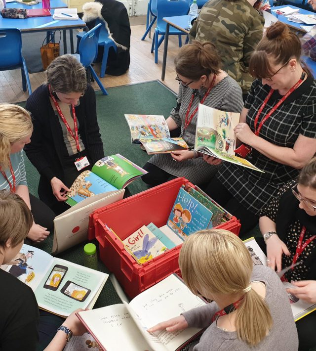 Photo of teachers reading books