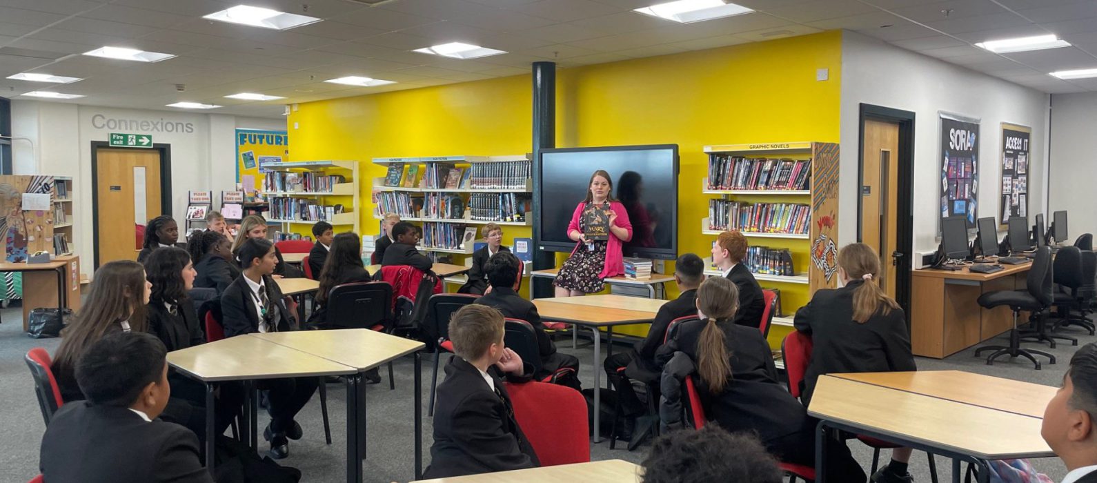 Image of librarian talking with students