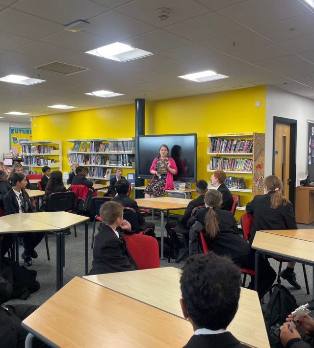 Image of librarian talking with students